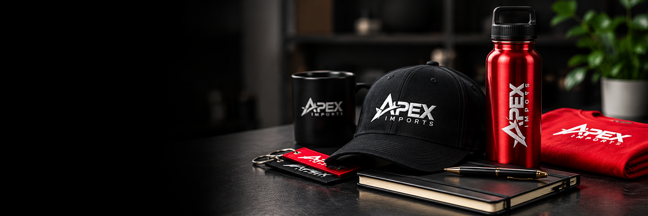 Branded cap, red bottle, and red hoodie on a desk